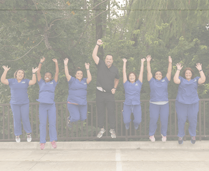 Garland pediatric dental team jumping outdoors