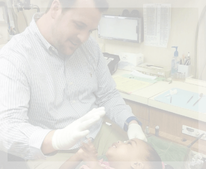 Garland pediatric dentist giving toddler a high five