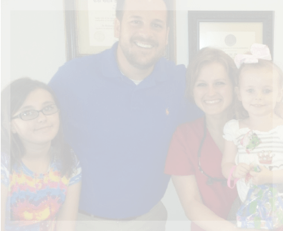 Pediatric dentist in Garland posing with mother and two children