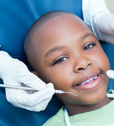 A young boy undergoes a dental checkup at a practice that offers dentistry for kids in Garland