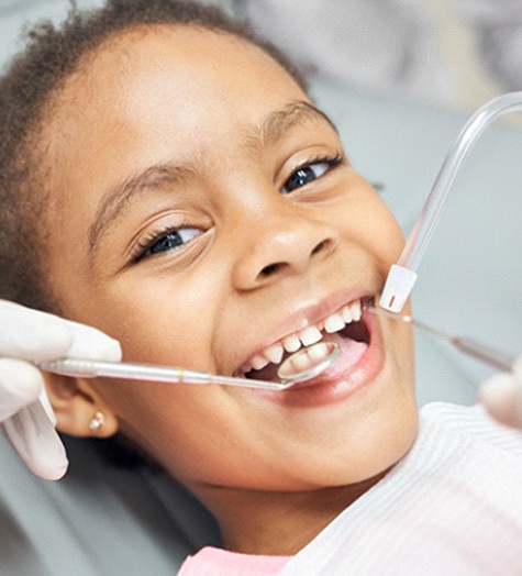 Little girl getting pulp therapy from Garland pediatric dentist