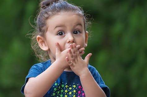 Young girl with children’s dental emergency in Garland