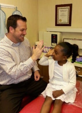 Doctor Preece giving young girl a high five