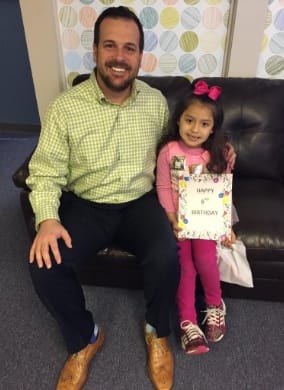 Doctor Preece and child sitting on couch together