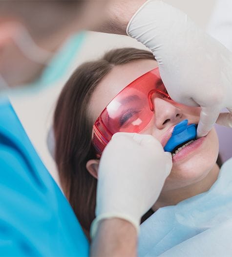 Child receiving topical fluoride treatment