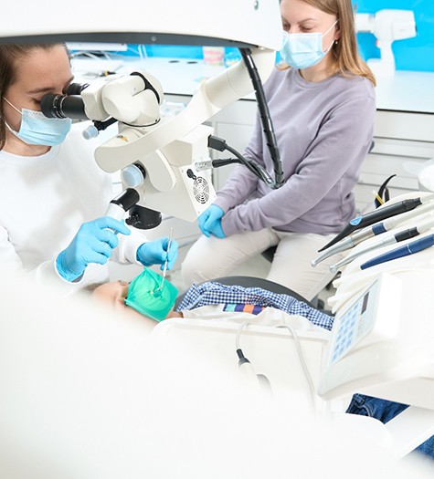 Young patient receiving pulp therapy