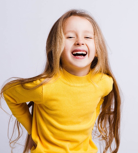 Little girl in yellow with a happy smile