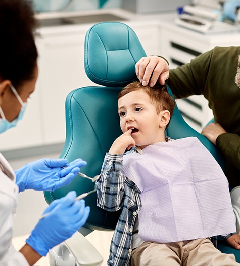 A little boy at the dentist with a toothache