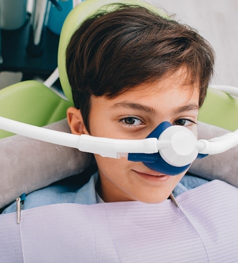Young boy with nitrous oxide sedation dentistry mask in place