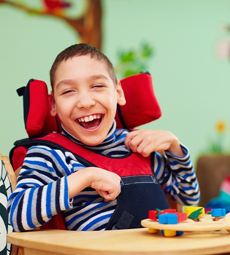 Little boy in wheelchair laughing