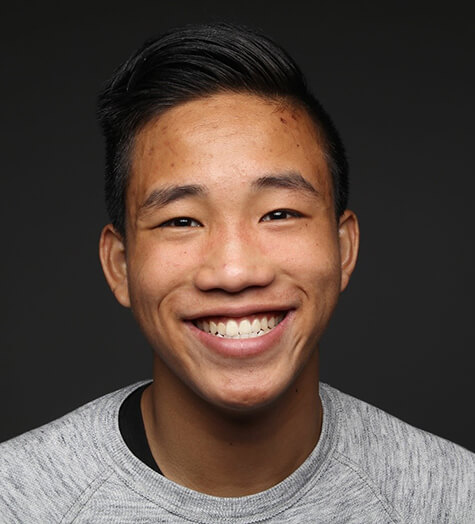 A male teen smiling after having a metal-free dental crown put into place