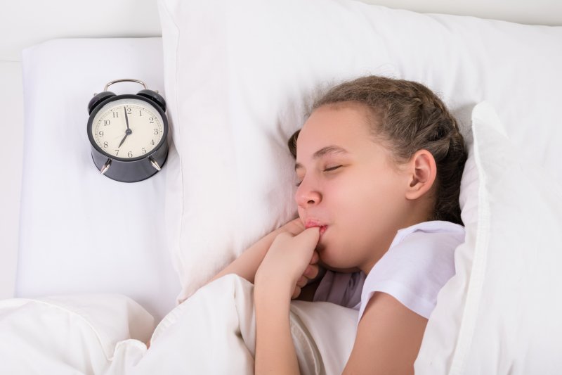 young girl sucking her thumb  