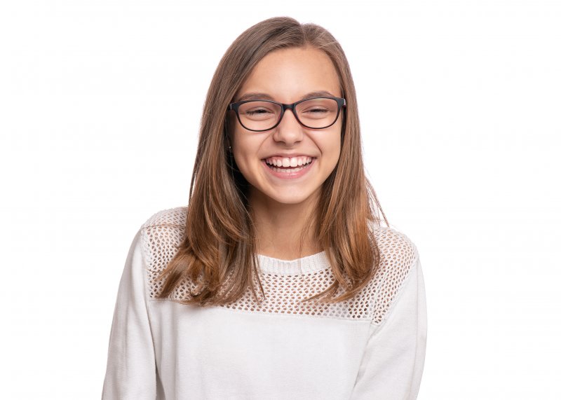 young girl smiling with healthy teeth  