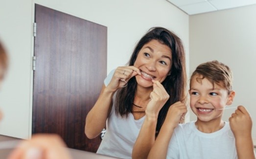 mom and son flossing their teeth
