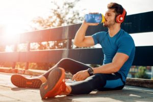 athlete drinking water after exercising