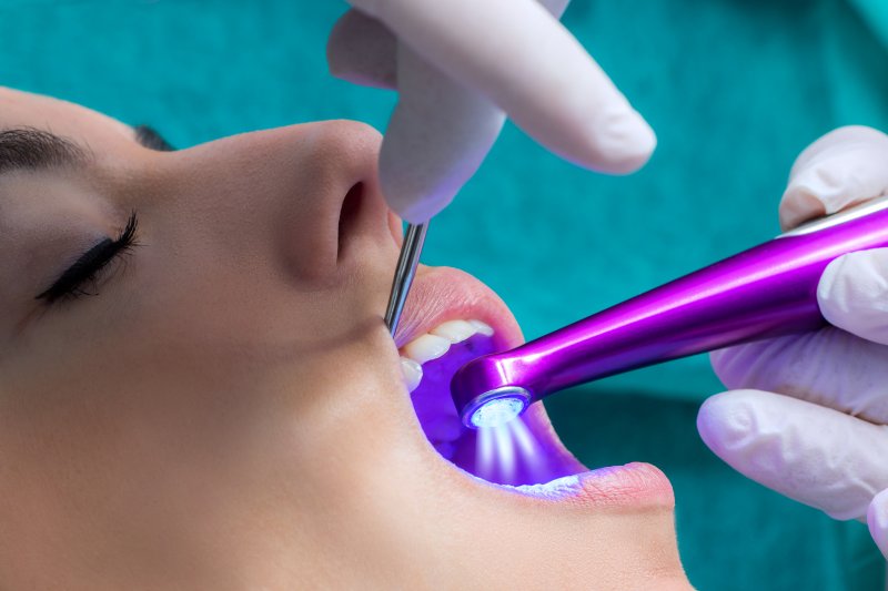 patient having a light shined on their tooth