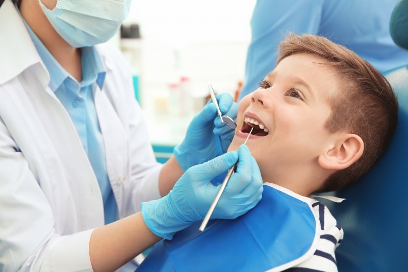 A young boy receiving care from a dentist
