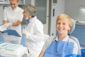 Teenager smiling at the dentist's office.